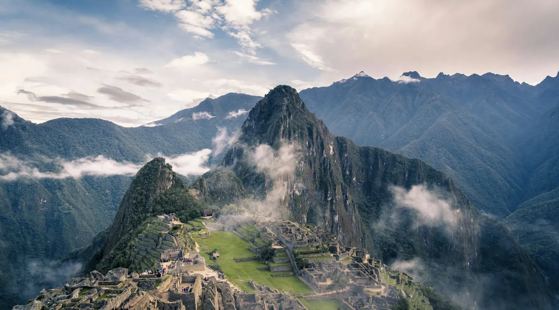 Machu Picchu ruins below Huayna Picchu in the clouds