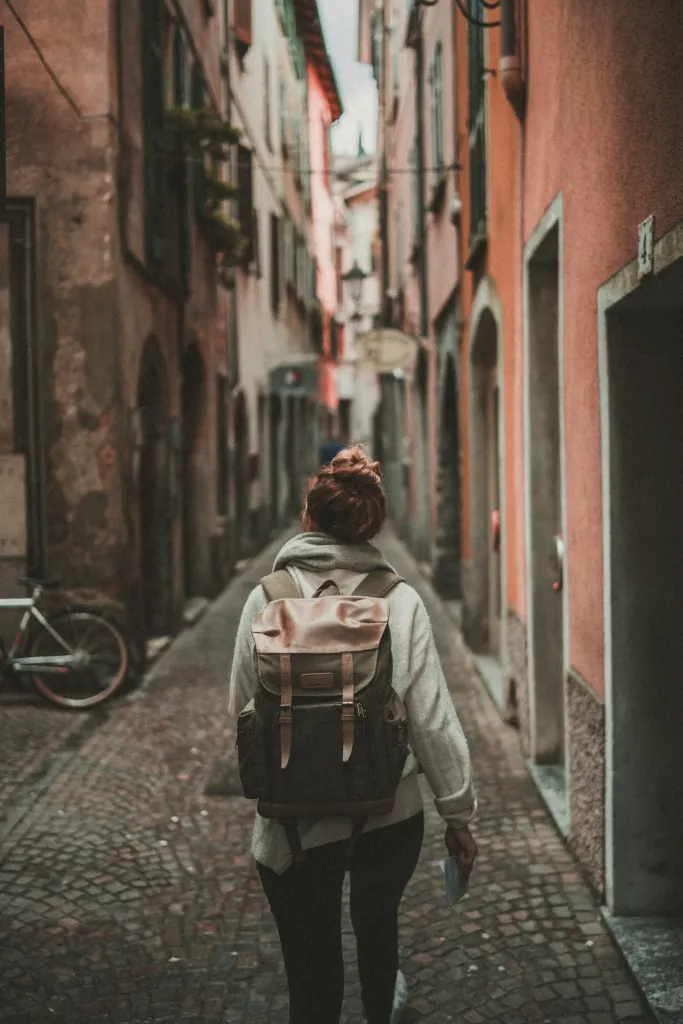 Traveler with a backpack walking a narrow European alley