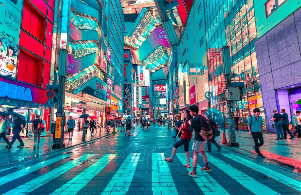 Neon-lit Tokyo shopping street with people crossing