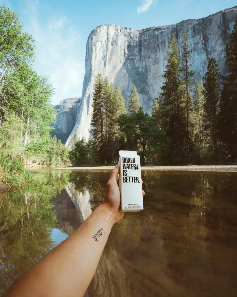 Hand holding a passport-sized notebook in Yosemite