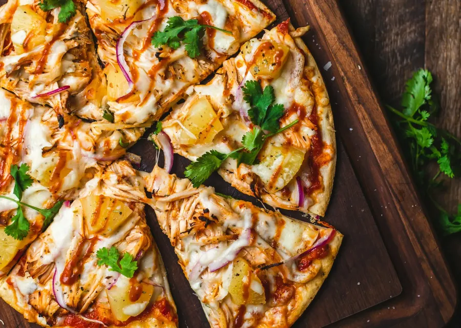 Thin-crust pizza on a wooden board