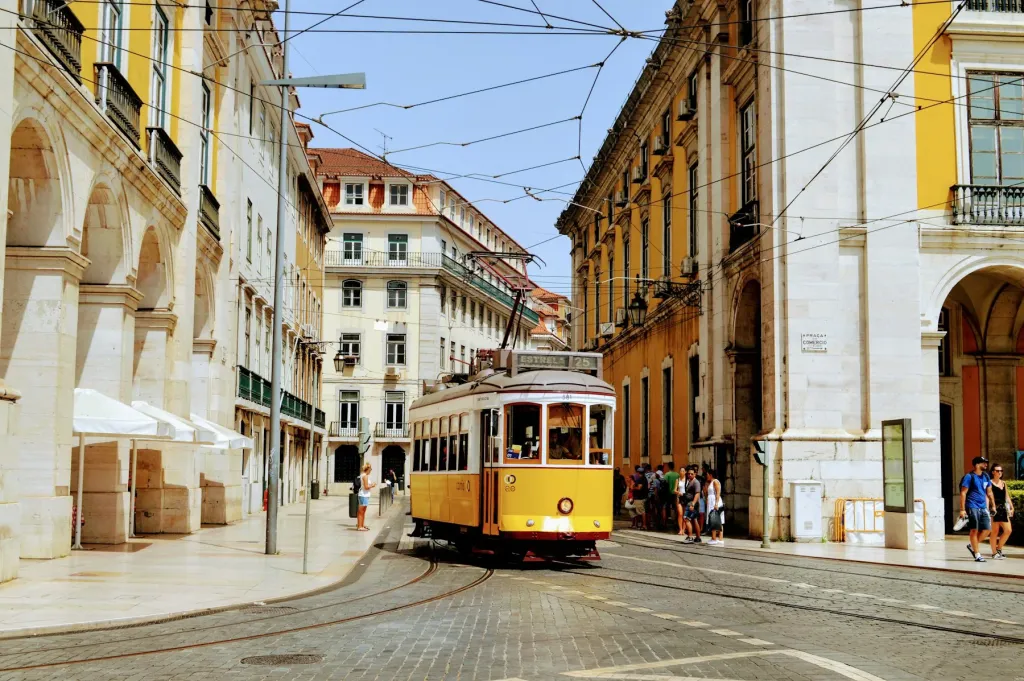 Yellow tram 28 on a sunny Lisbon street