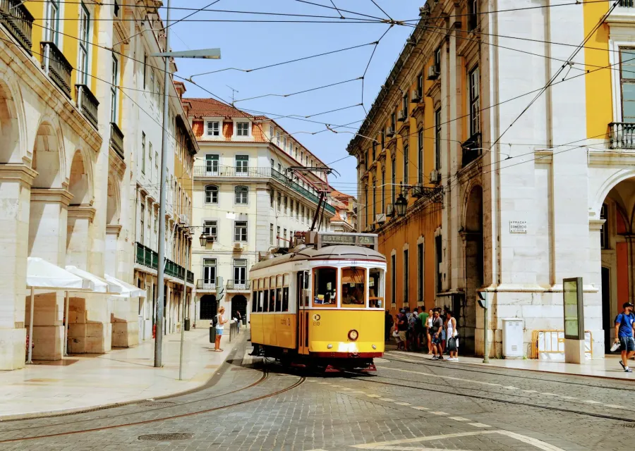 Yellow tram 28 on a sunny Lisbon street